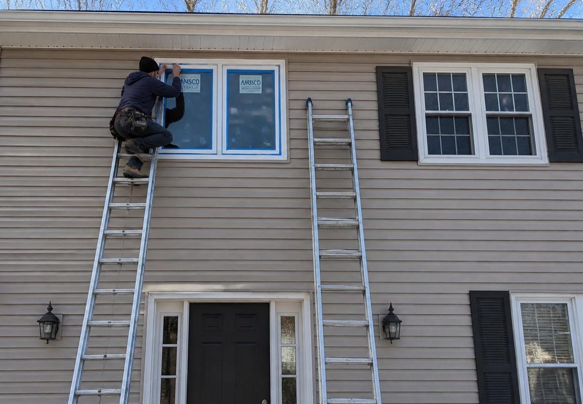 Installer taping off new impact windows